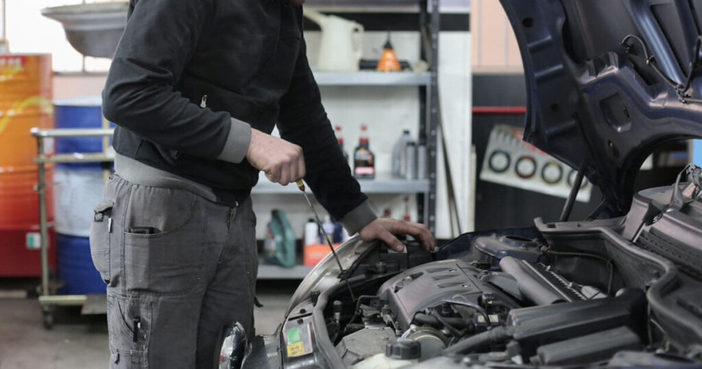 male mechanic inspecting car's engine of recruitment agency for new zealand