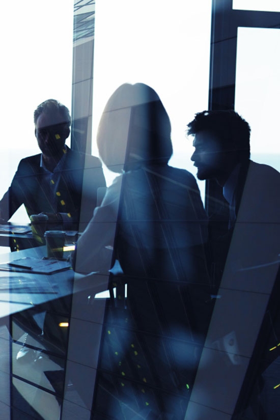 Three employees participating in a business meeting